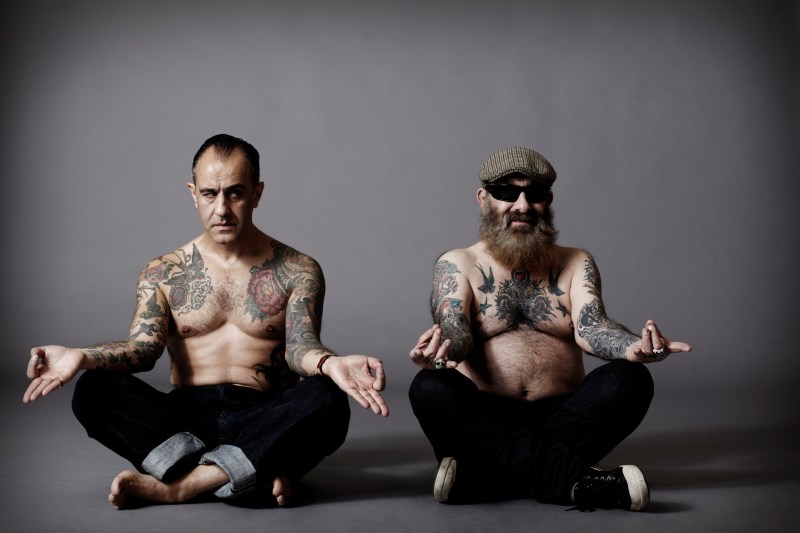 Two-Tattooed-Men-Sitting-Down
